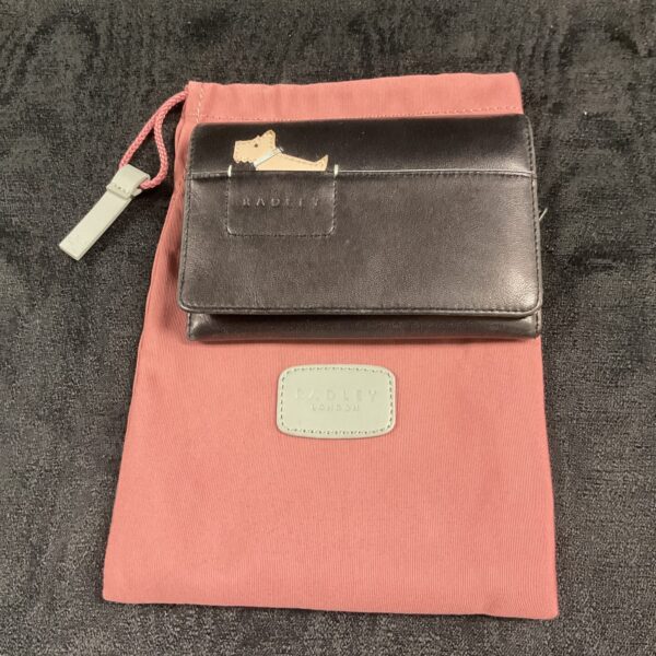Radley London leather purse with cloth dust bag, front view.