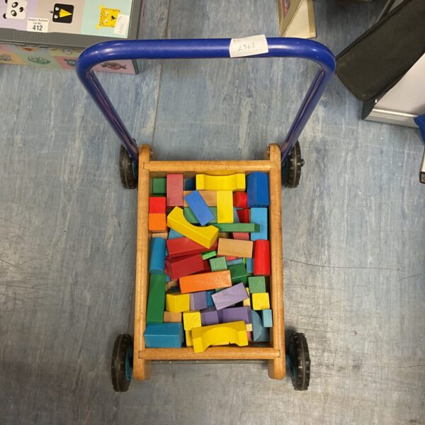 Colourful vintage wooden building blocks in a small cart.
