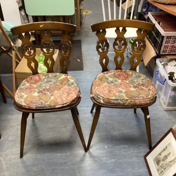 Pair of vintage Ercol Fleur de Lys dining chairs with patterned seats.