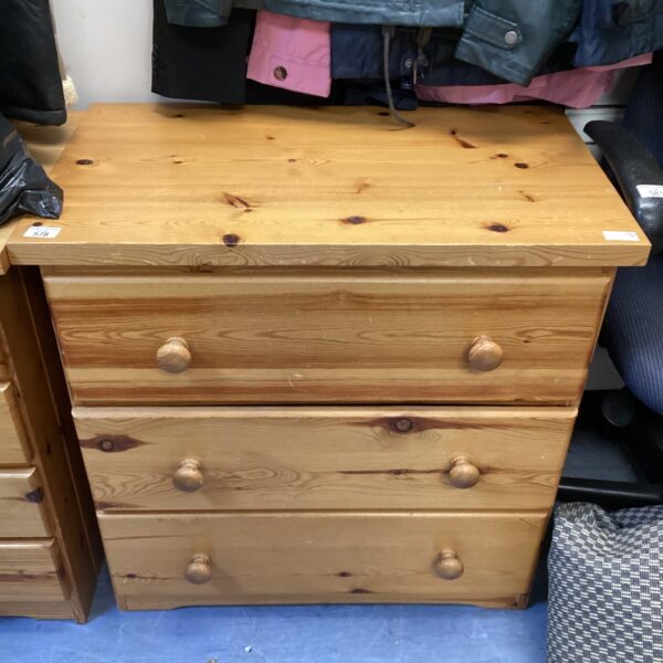 Front view of a vintage pine chest of drawers.