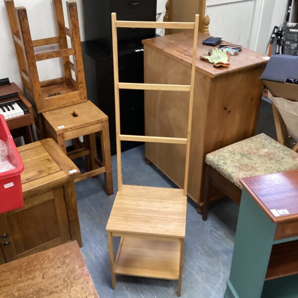 Rustic wooden bathroom chair with towel rail.