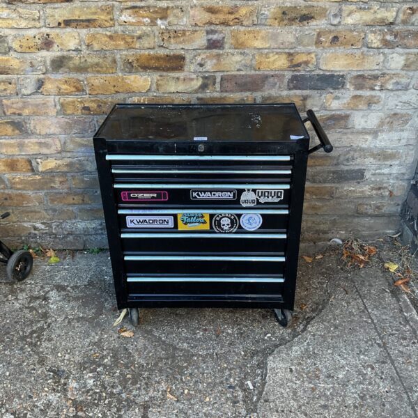 Black mechanic tool station with drawers for garage storage.
