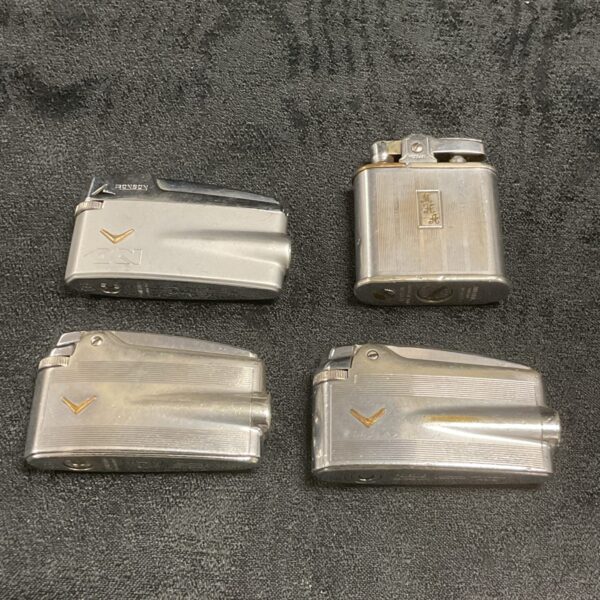 Lot of four vintage Ronson lighters in metal finish.