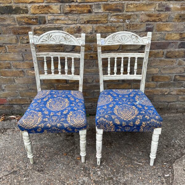 Pair of shabby chic chairs with blue and gold seats.