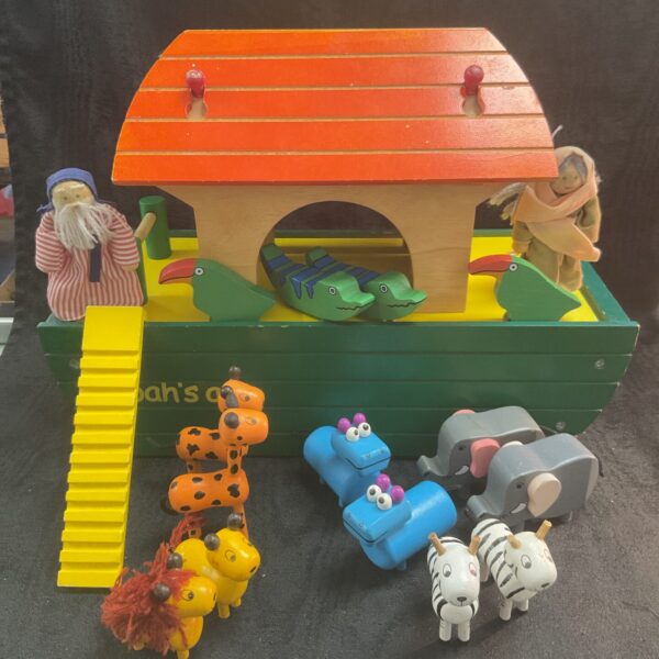 Vintage wooden Noah’s Ark with colourful animal figures and ladder.