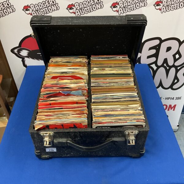 Vintage suitcase filled with a large 7-inch vinyl record collection.