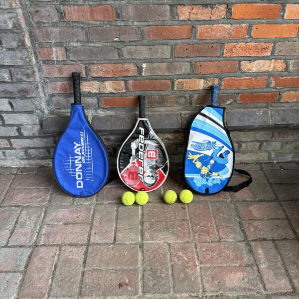 A colourful set of junior tennis rackets and balls for kids.