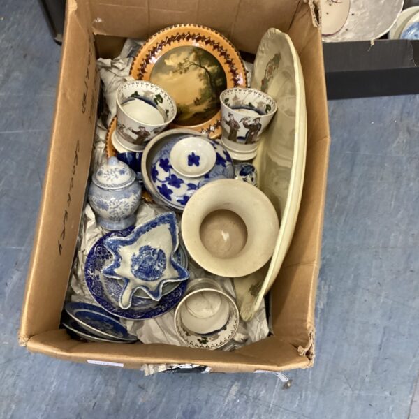 Mixed lot of vintage pottery and ceramic collectibles on display.