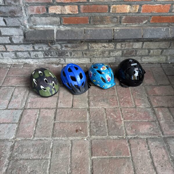 Assorted children’s safety helmets for cycling and skating.