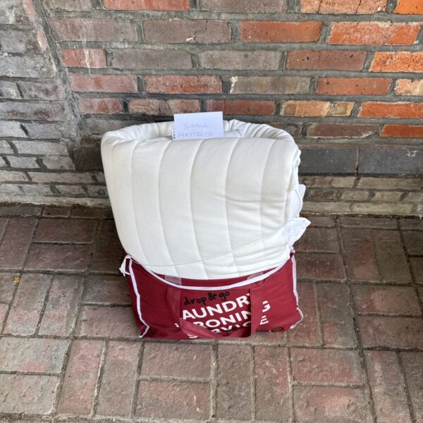 White padded single mattress cover in unused condition.