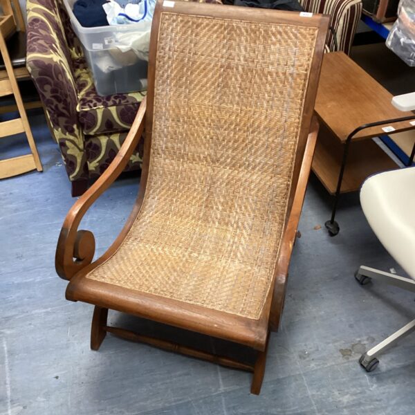 Vintage British Colonial planter chair with woven rattan seat.