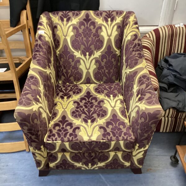 Vintage purple patterned armchair, mid-century style seating.