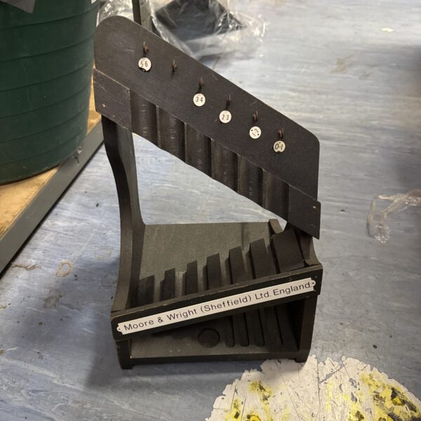 Vintage Moore & Wright tool rack for workshop storage.