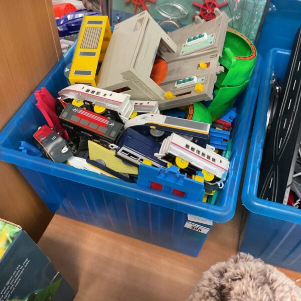 Vintage Tomy playsets and vehicles in a colourful toy lot.