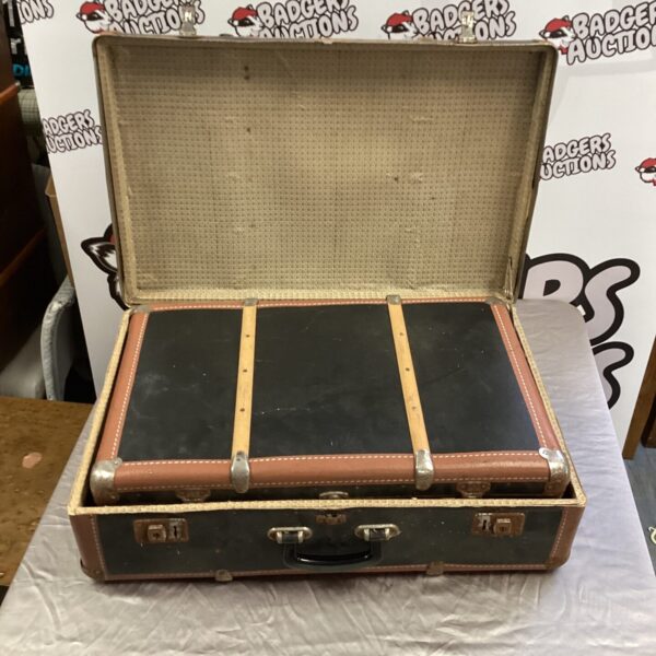 Pair of vintage brown suitcases, classic travel luggage.