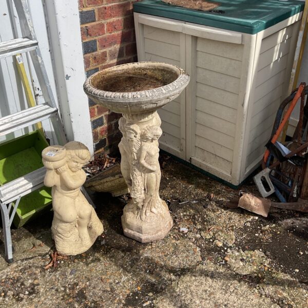 Tiered stone garden bird bath for attracting birds outdoors.