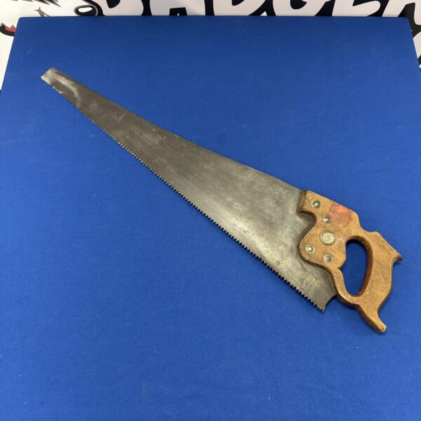 Vintage Disston wood saw with wooden handle and steel blade.
