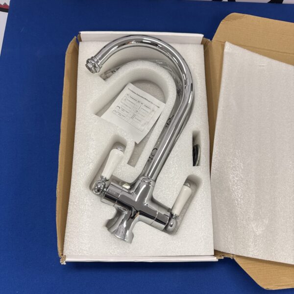 New chrome kitchen mixer tap for sink installation.