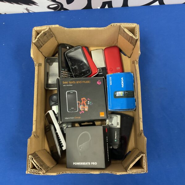Mixed lot of vintage mobile phones and Beats earbuds for collectors.