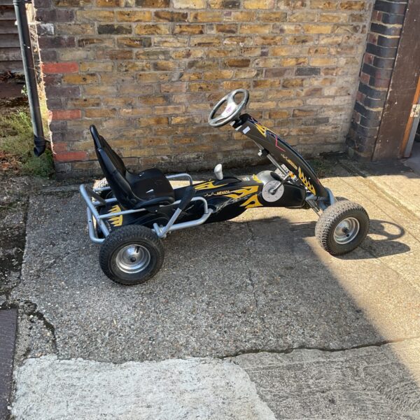 Vintage Evarda peddle go kart for children's outdoor play.
