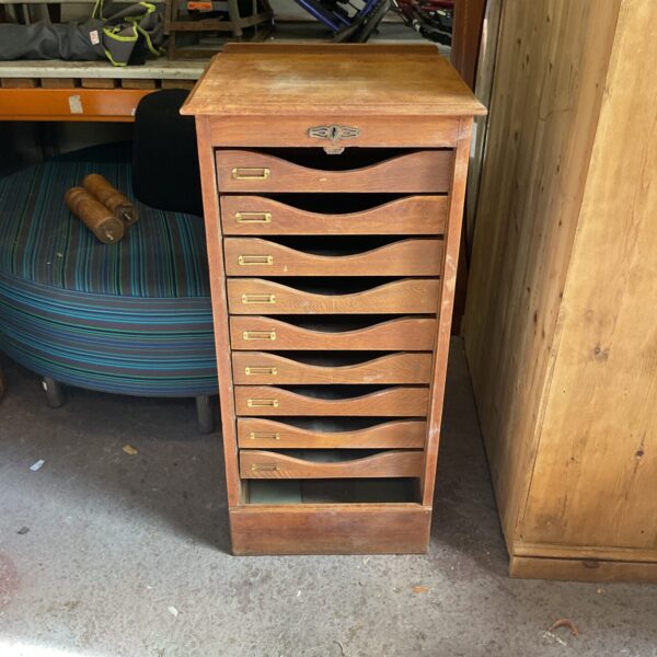 Vintage oak tambour filing cabinet with roll-top door.
