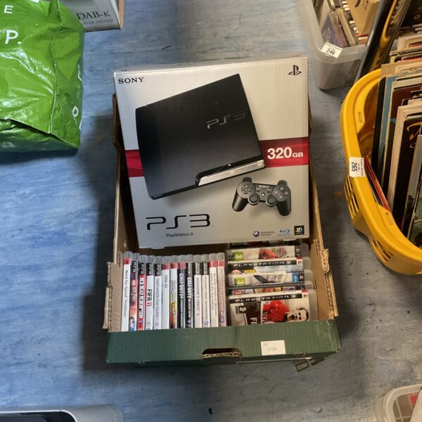 Boxed Sony Playstation 3 gaming console with games.