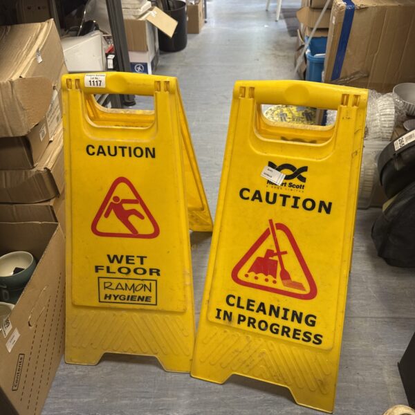 Yellow wet floor caution signs for safety and cleaning.