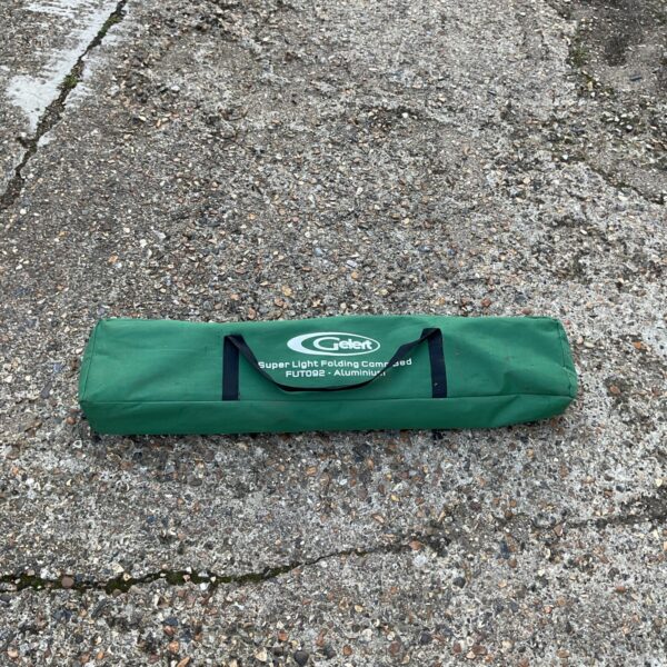 Folded Gelert lightweight camping bed ready for storage.