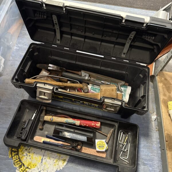 Large Stanley toolbox filled with various hand tools and workshop essentials.