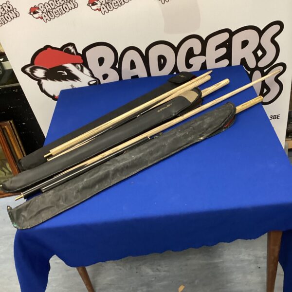 Lot of five pool cues including a Riley cue for billiards.