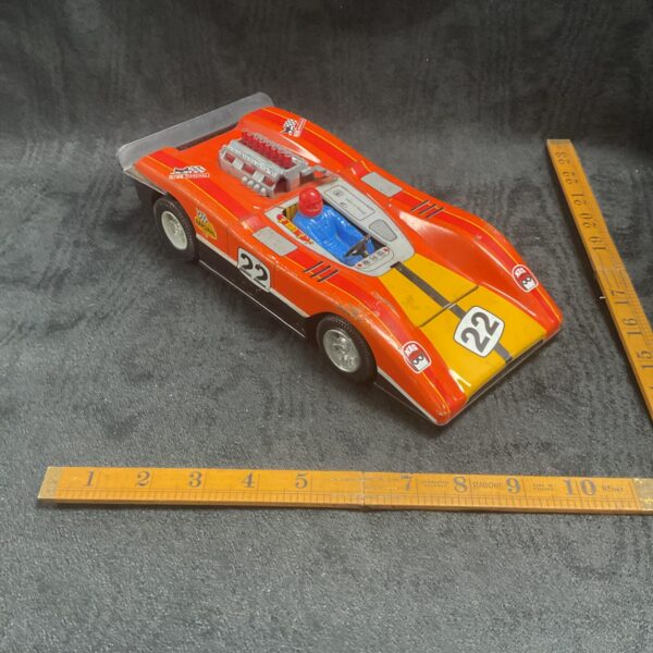 Vintage French tinplate race car number 22, collectible toy.