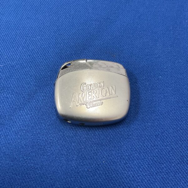 Vintage Golden American Classic lighter with embossed branding.