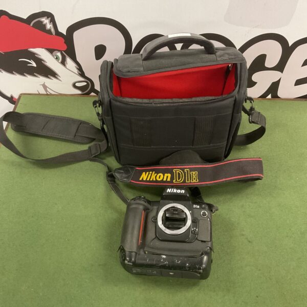 Nikon D1H camera with strap and bag, vintage digital SLR.