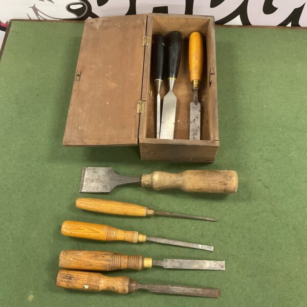Vintage carpenter's chisels in wooden box, antique woodworking tools.