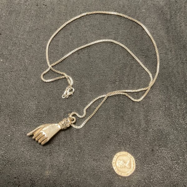 Antique Victorian spiritual hand pendant on a long chain.