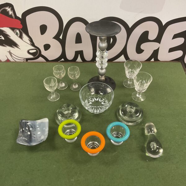 Mixed glassware collection including candle holders and egg cups.
