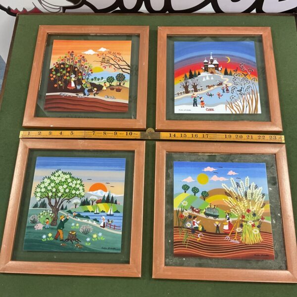 Set of four framed Barbara Furstenhofer tile art pieces with folk art scenes.