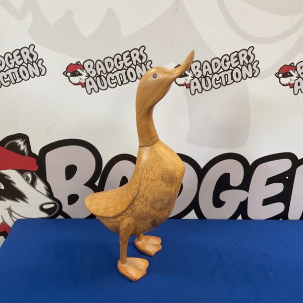 Hand-carved wooden duck, detailed carving, folk art décor.