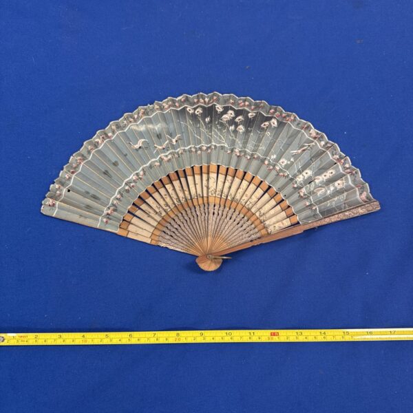 Vintage oriental fan with bird and blossom design.