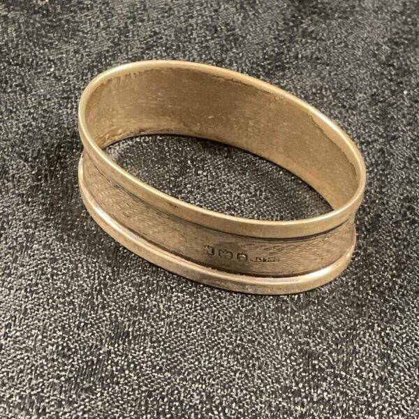Hallmarked silver napkin ring for elegant table settings.