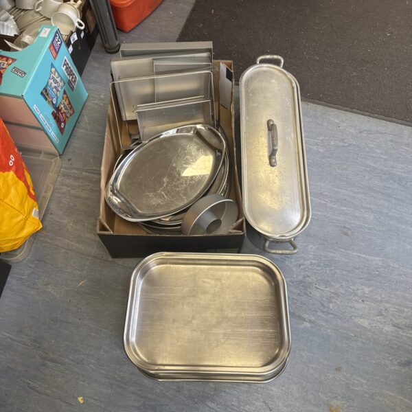 Stainless steel catering trays and fish kettle for buffet service.