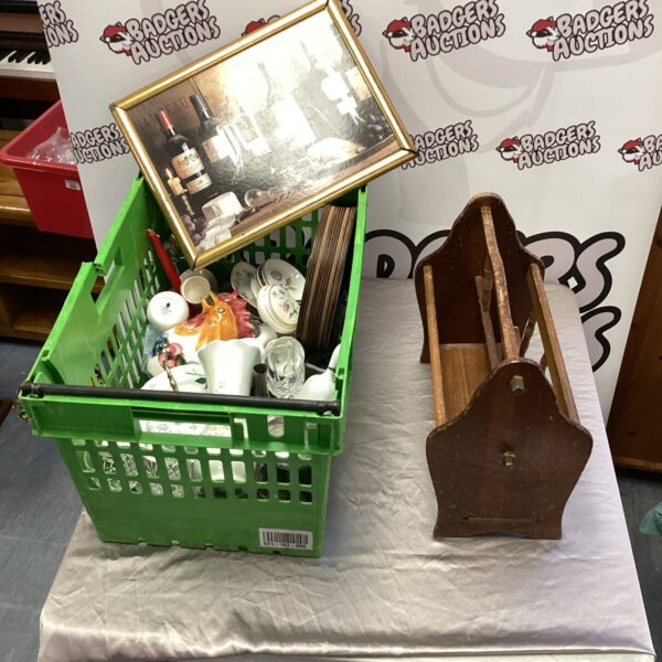 Crate of mixed kitchenware including plates and a tray.