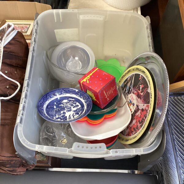 Mixed kitchenware lot in a crate, including dishes and plates.