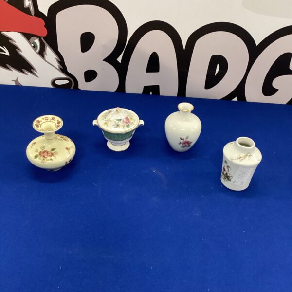 Delicate Limoges porcelain vases with floral designs.