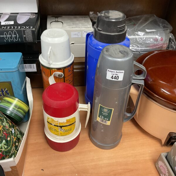 Lot of four vintage retro thermos flasks in various colours.