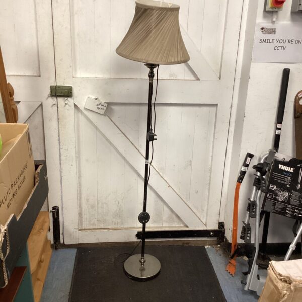 Vintage black standard lamp with cream lampshade for reading.