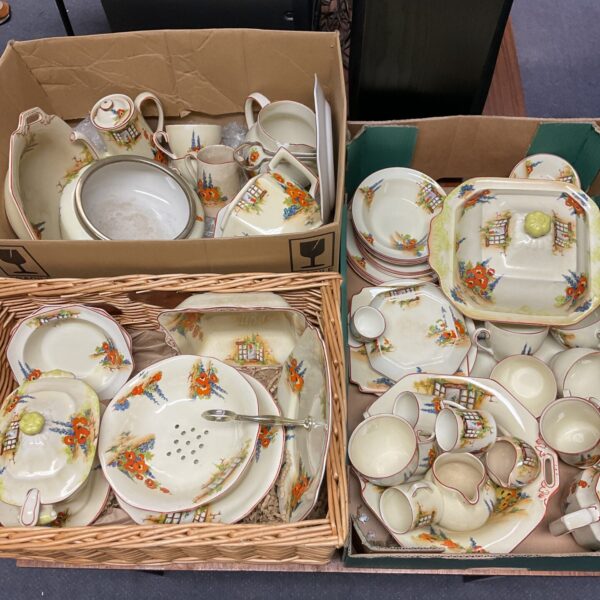 Vintage floral tea set with cups, saucers, and serving pieces.