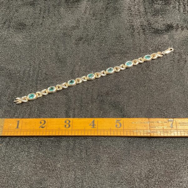 Close-up of 925 silver bracelet with blue stones.
