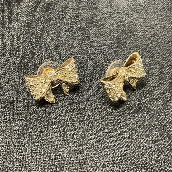 Elegant 9ct gold bow earrings with white stones.