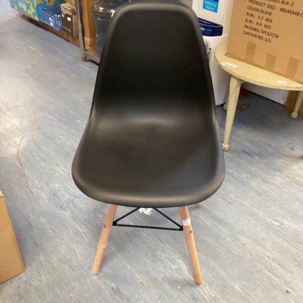 Black Ainpecca chair with wooden legs, modern dining seating.